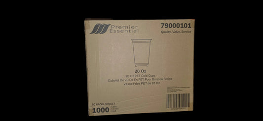 Box of Premier Essential 20 oz cups on a wooden surface with a person's leg and shoes in the background.